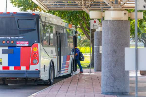 A student boards a METRO bus.